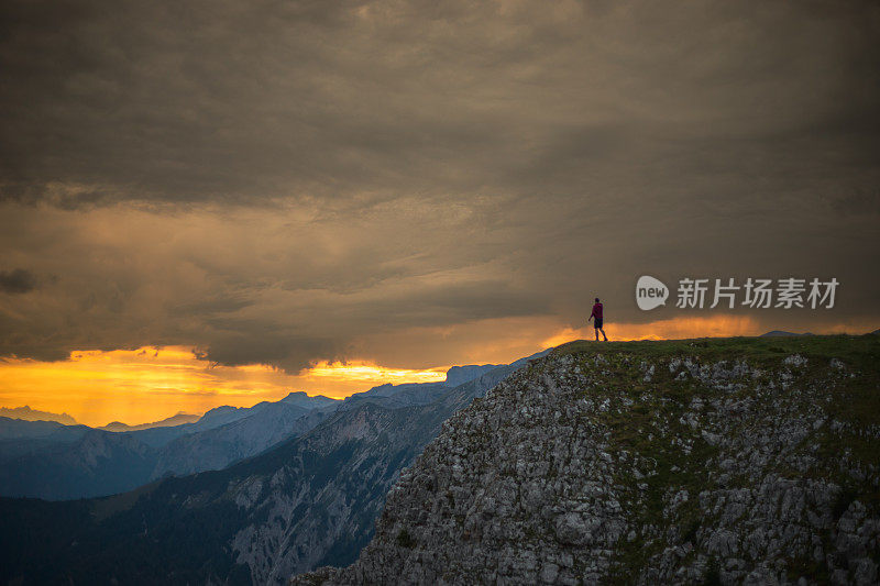 Male hiker enjoying scenic view while standing on top of mountain. Aflenzer Bürgeralm